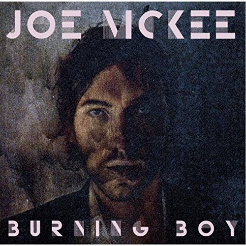 Album cover with a man's face, partially shadowed, and white text "Joe McKee Burning Boy".