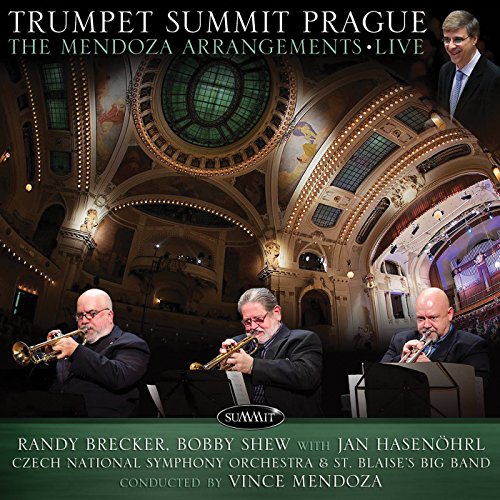 Three trumpet players perform on stage in a grand concert hall.