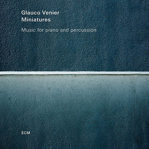 "Album cover with dark blue textured background, white text, and a thin white stripe."