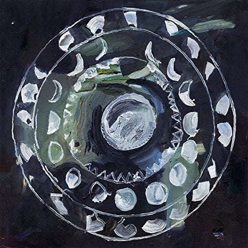 The alt text for the image is: "Colorful vinyl record with abstract, spiral design on a black background."