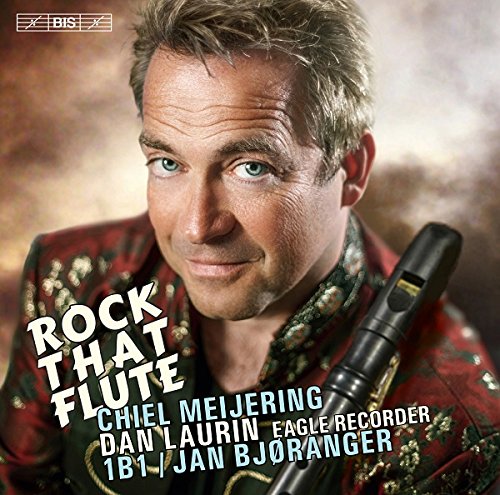 Man holding a recorder, wearing a red jacket, on a music CD cover.