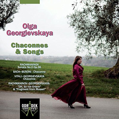 "CD cover featuring a woman in a red dress walking on a road."