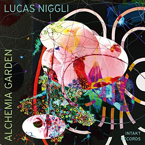 The image is a music album cover featuring a vibrant, abstract design. For accessibility purposes, a suitable alt text could be: "Album cover with abstract, colorful shapes and text."