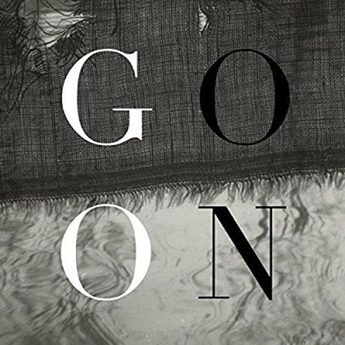 The image shows a black and white design with the text "GO ON". For accessibility purposes, a suitable alt text could be: "Black and white image with 'GO ON' text on layered fabric."