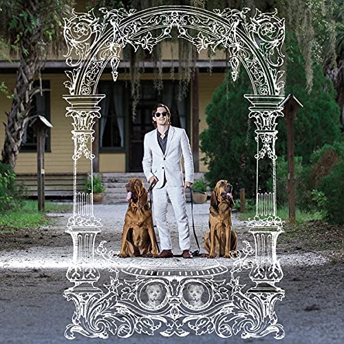 Man with two Irish Wolfhounds framed by an ornate, white archway.