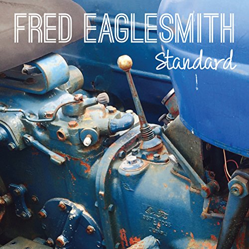 Album cover featuring a close-up of a rusty, blue tractor transmission and gearshift.