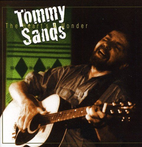 "Tommy Sands CD cover featuring a man playing guitar, smiling, against a green background."