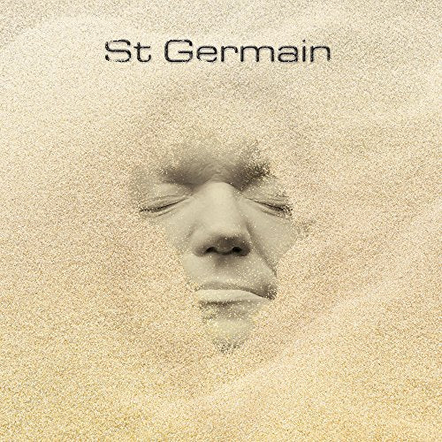 Album cover for St Germain, featuring a face dissolving into sand.