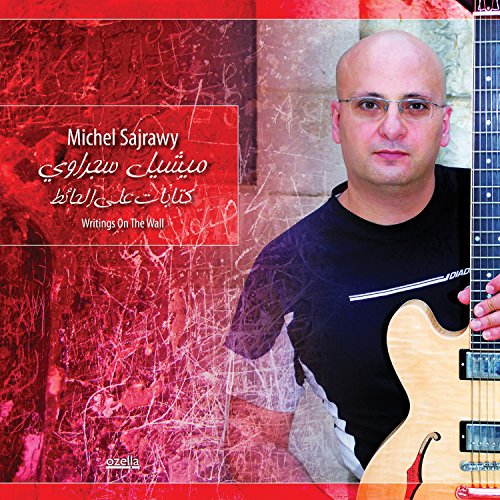 "Album cover featuring a man holding a guitar against a red, graffiti-covered background."