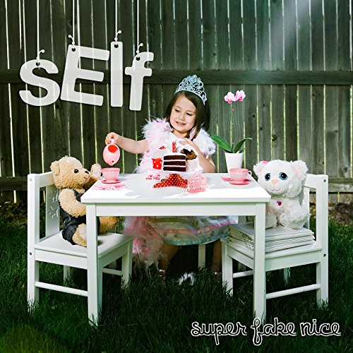 A young girl in a tiara sits at a tea table with stuffed animals.