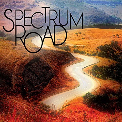 The image depicts a winding road through hills with the text "SPECTRUM ROAD" superimposed.