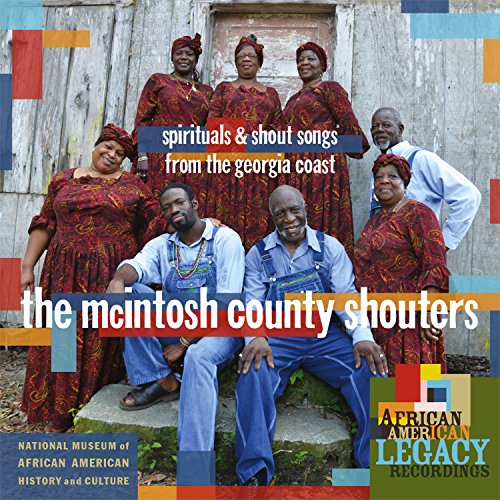 "CD cover with group of people in traditional clothing posing outdoors."