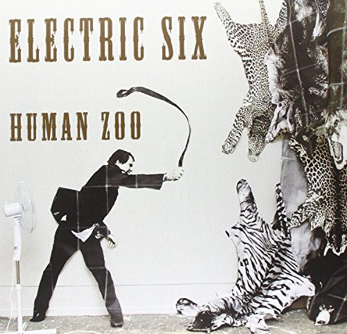 Album cover: Electric Six's "Human Zoo" with animal imagery and a man with a whip.