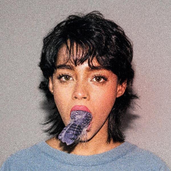 Close-up portrait of a person with a purple mantis shrimp in their mouth.