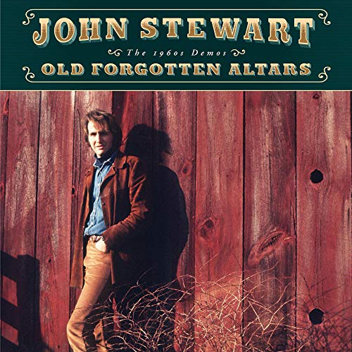 CD cover featuring a man leaning against a red wooden barn door.