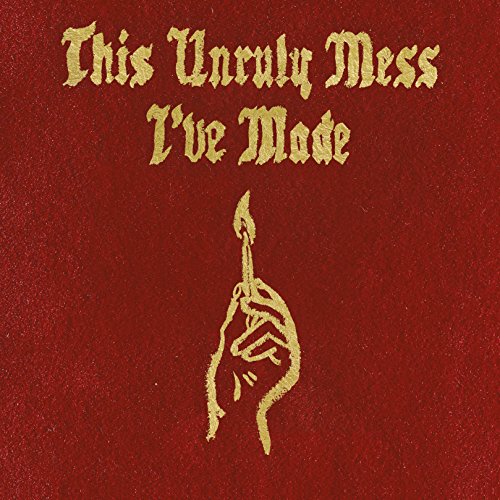 Red album cover with gold text and a hand holding a torch.