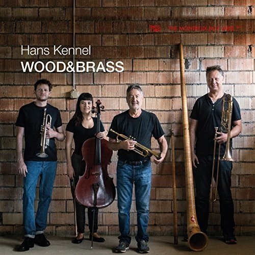 "Album cover featuring four musicians holding various instruments against a brick wall."