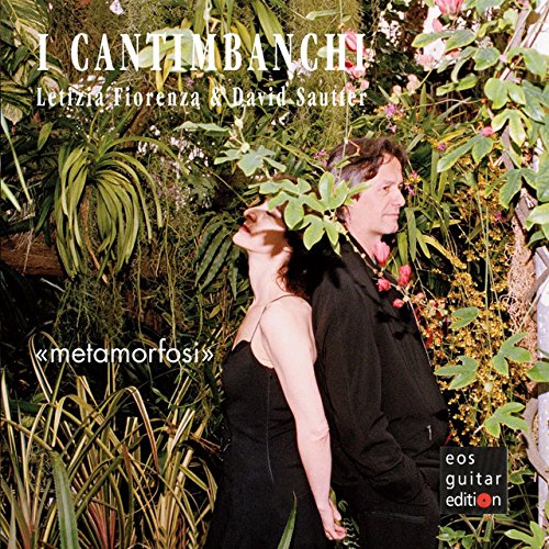 CD album cover with a man and woman standing amidst lush greenery.