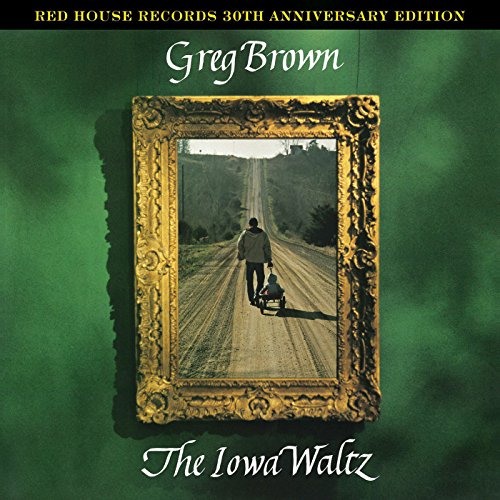 "Album cover with man pushing a stroller down a road, framed in gold."