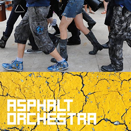 Musicians in denim and boots performing on cracked yellow asphalt.
