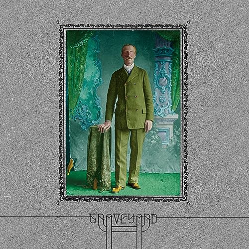 Album cover: Man in green suit stands before ornate, faded backdrop.