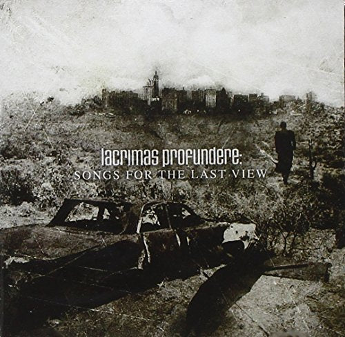 "Album cover with a man walking towards a cityscape, with a wrecked car nearby."