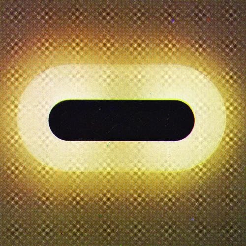 Abstract yellow vinyl record cover with a central black and white shape.
