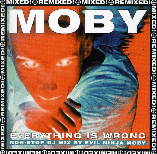 "Moby album cover with a man's face and bold text on orange background."