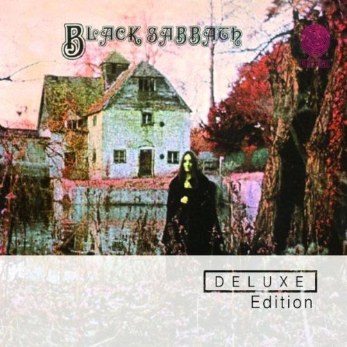 "Album cover with a figure in black standing in front of an old house."