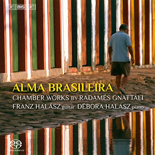 "CD cover featuring a man walking between colorful wooden slats on a cobblestone path."