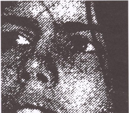 A black and white, heavily pixelated image of a person's face with a serious expression.