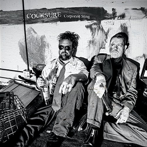 "Black and white CD cover with two men sitting on a couch holding bottles."