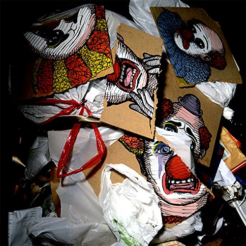 A pile of crumpled paper bags with clown face illustrations on a black background.