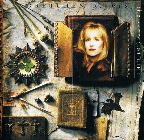Gretchen Peters album cover featuring a blonde woman's portrait amidst old books and decorative items.