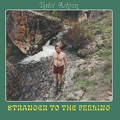 Album cover: Man in stream with rocky landscape, "Stranger To The Feeling".