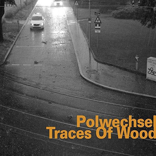 "Album cover with a black and white road scene and orange text."