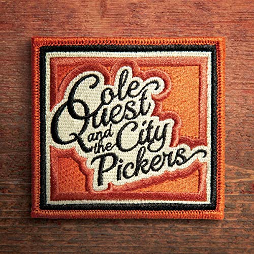 Orange embroidered patch with "Cole Quest and the City Pickers" text on a wooden surface.