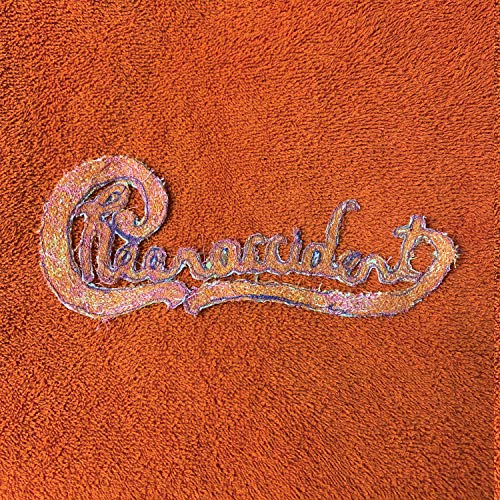 The image shows a close-up of an orange suede surface with the word "Cheer-Accident" embossed in cursive script. For accessibility purposes, a suitable alt text could be: "Orange suede surface with 'Cheer-Accident' embossed in cursive."