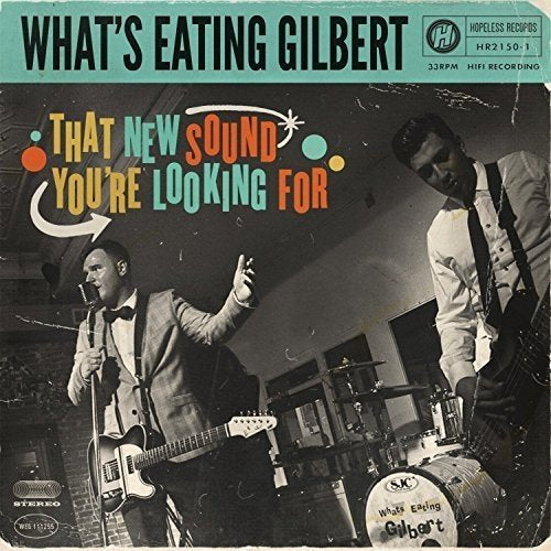 Album cover with two men playing instruments, colorful text, and a teal banner.