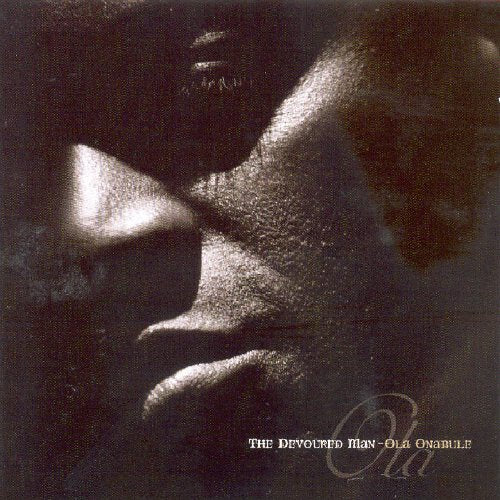 "CD cover with a close-up of a man's face in dark, monochromatic tones."