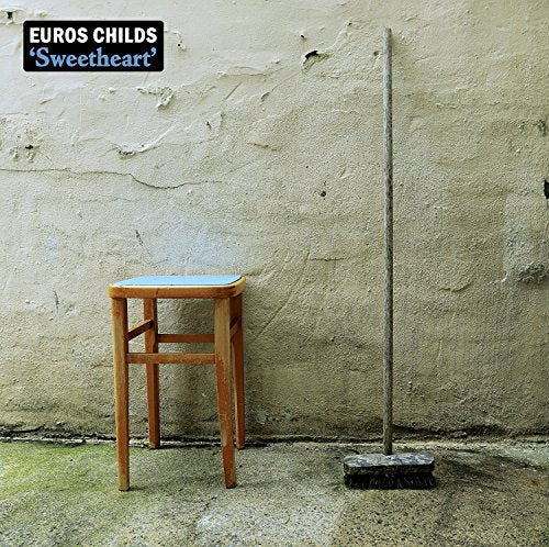 CD cover: stool and broom leaning against a textured wall.