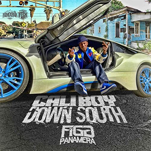 Rapper sitting in the driver’s seat of a light green Porsche with blue rims.