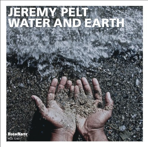 "Album cover with hands holding sand and water flowing in the background."
