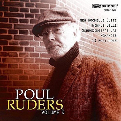 "Album cover featuring a man in a hat and coat against a brick wall."
