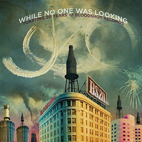 Album cover with cityscape, fireworks, and bottle on a building, celebrating 20 years.