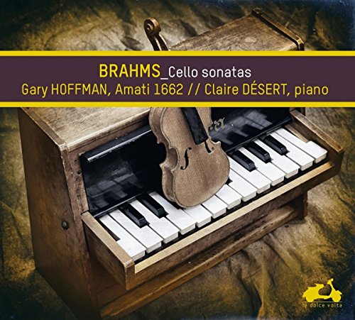 CD case with a violin resting on an antique piano keyboard.