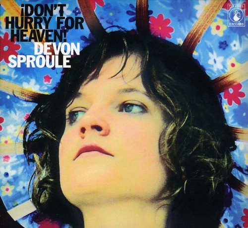 "Album cover featuring a woman with dark hair and floral background."