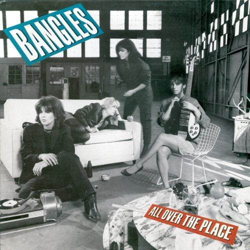 "Black and white album cover with four women in a cluttered room."