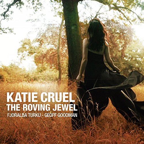 "Katie Cruel's album cover: a woman in a black dress in a forest."