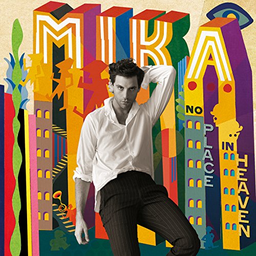 Mika posing in front of a colorful, abstract illustration with stylized buildings and text.